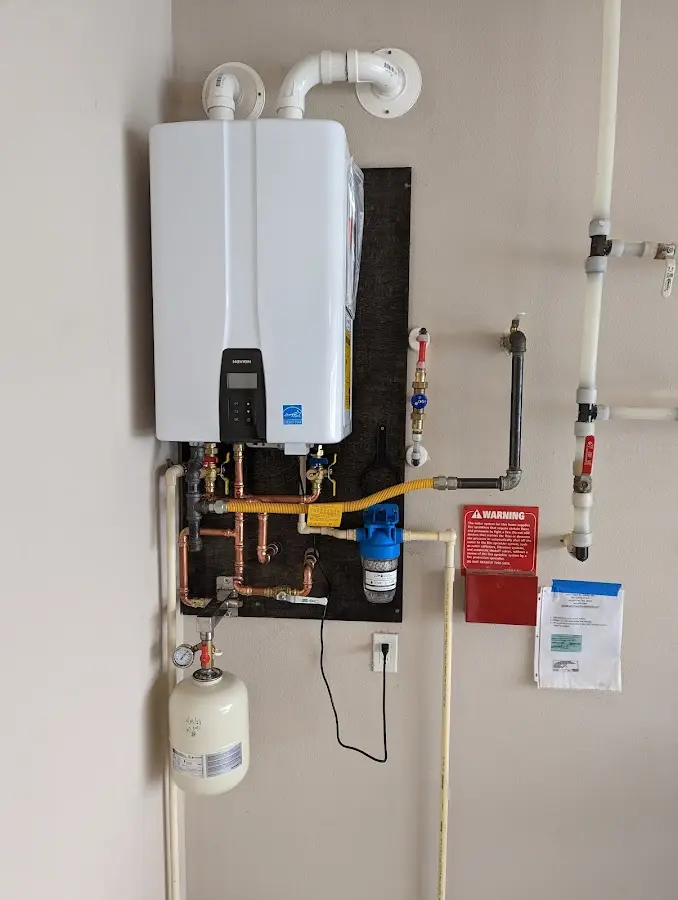 Professional plumber installing copper piping in a London home